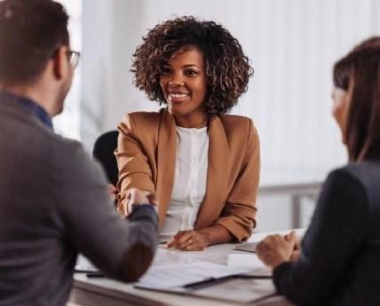 Business professionals building relationships through a referral networking meeting.