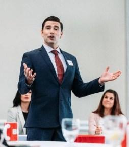Business professional presenting at an in-person networking meeting.
